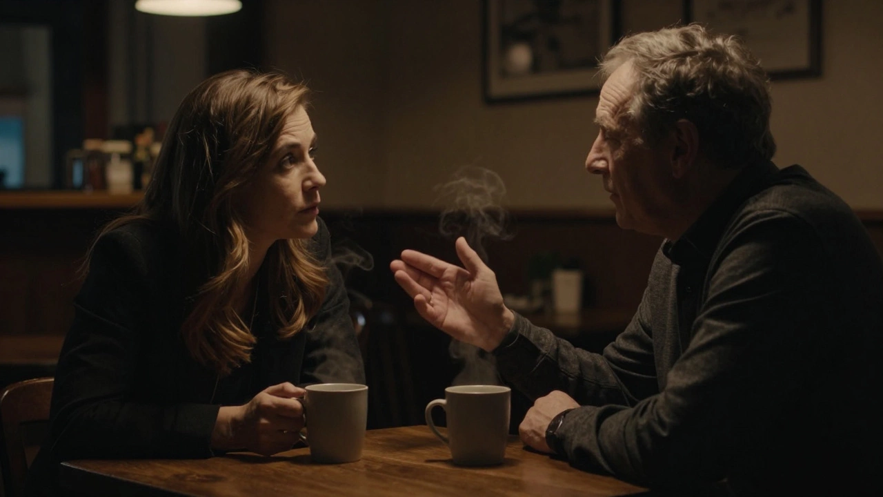 A woman and client share a quiet conversation in a Manchester café, emotional connection evident in their posture.